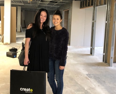 Farica and Hadley touring the new office