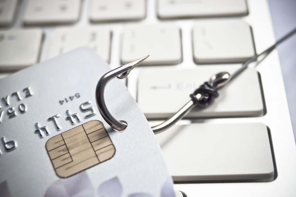 credit card on fishing hook with keyboard in background