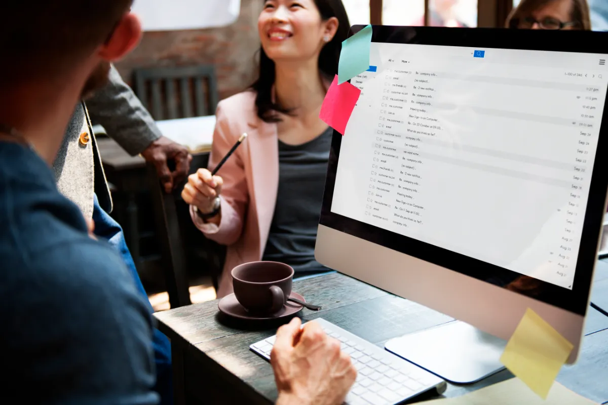 Business colleagues chat while data is migrated across servers