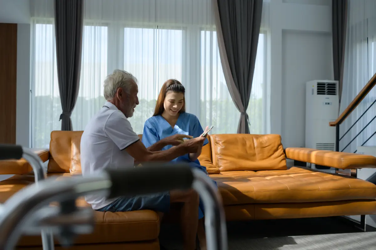 Nurse and patient in care home discuss results of the physical examination