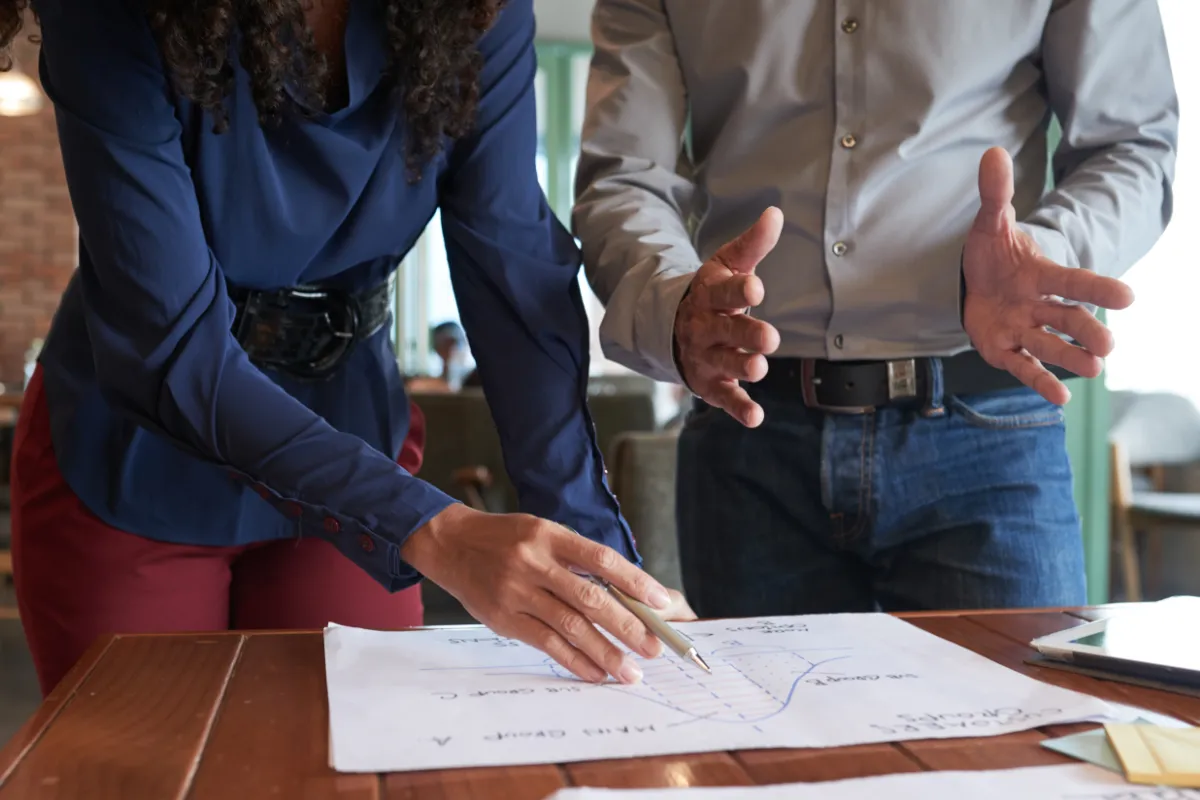 Two colleagues conducting review of infrastructure graph