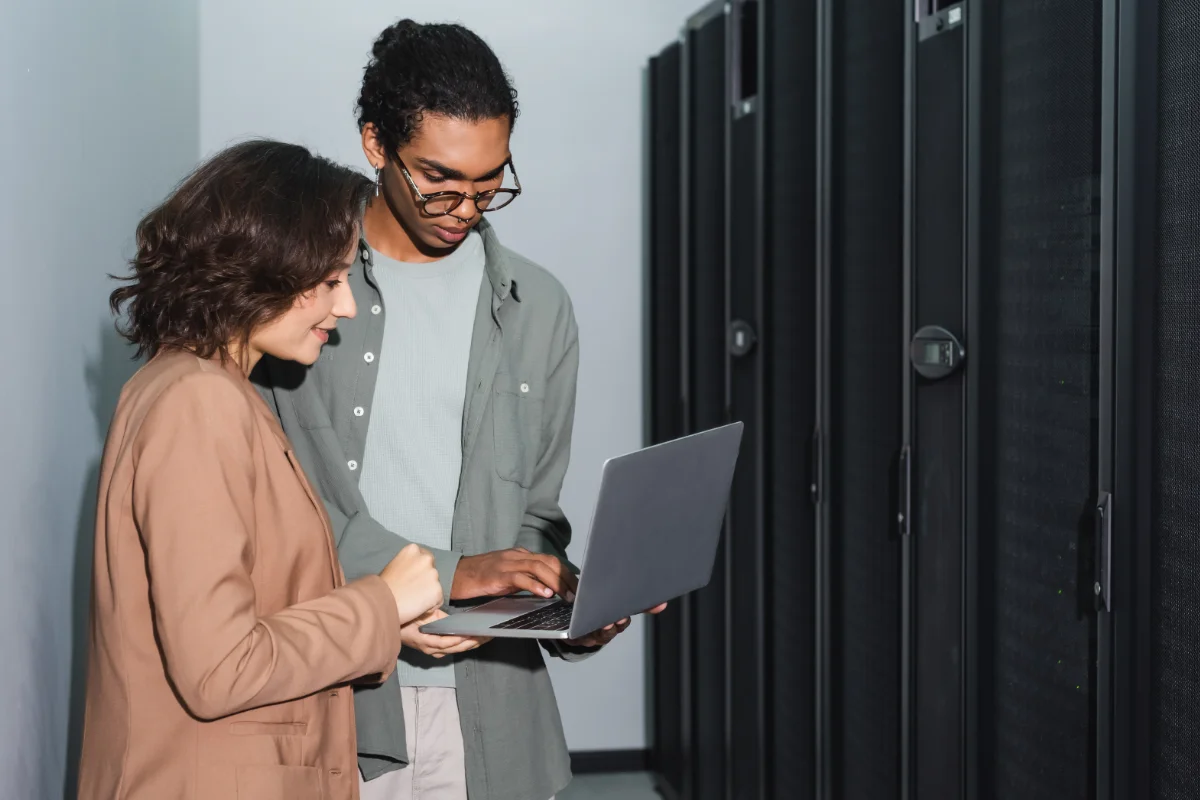 engineers using laptop to backup while working in data center