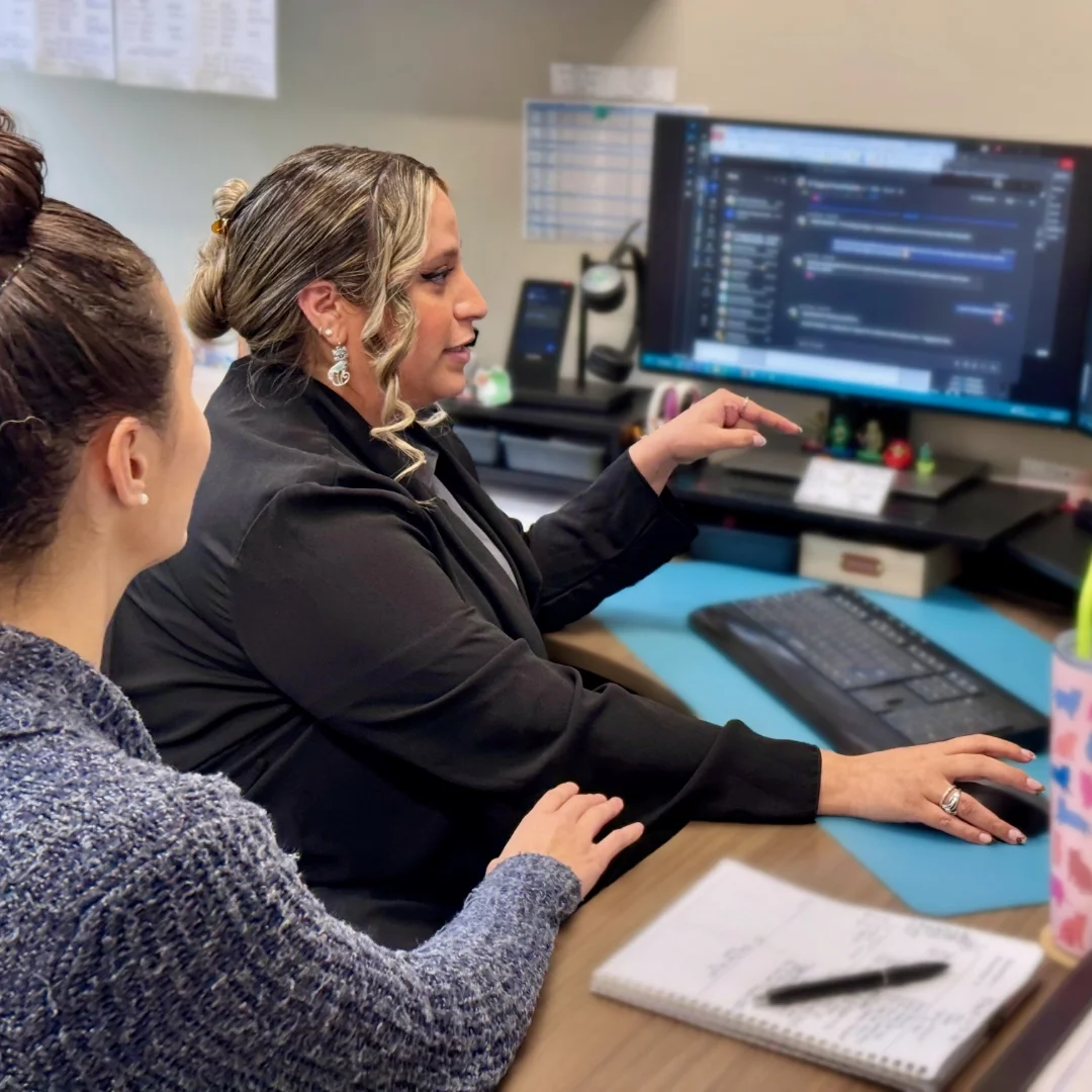 Anderson colleagues working together on project at desk