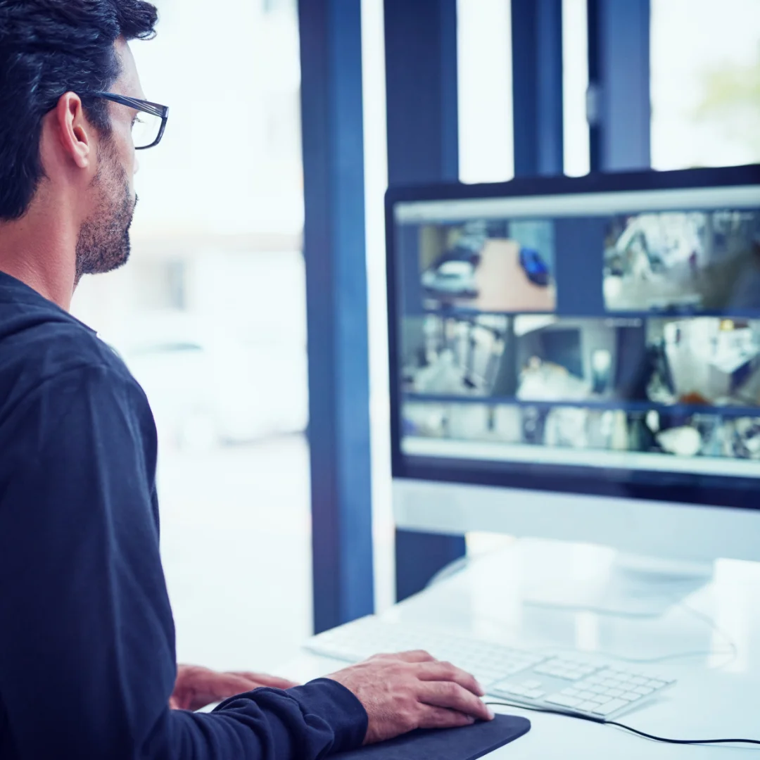 cropped-shot-of-a-man-watching-security-footage