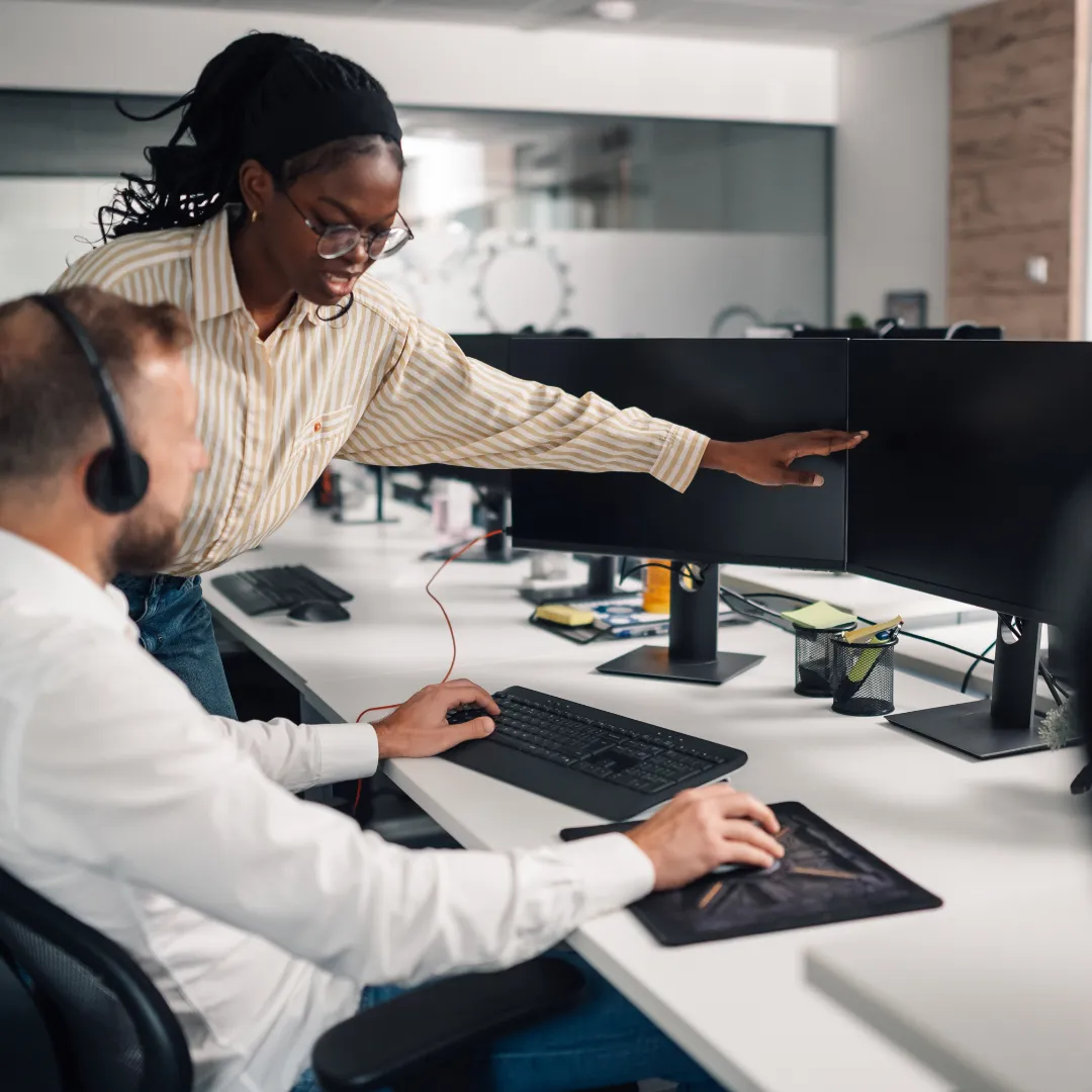 Colleagues helping each other work in office