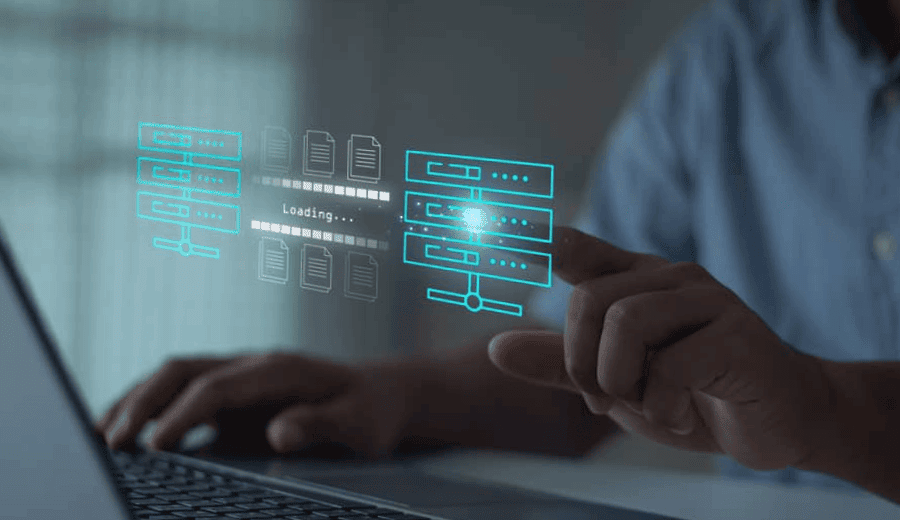 Man moving data across digital servers on laptop